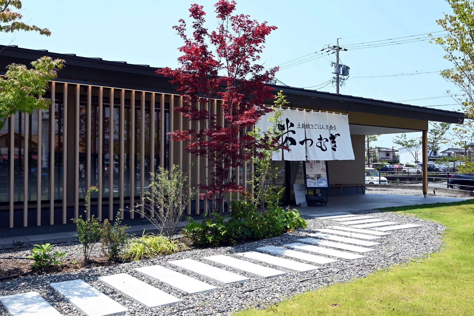 土鍋炊きごはん定食屋「米つむぎ」の外観と暖簾